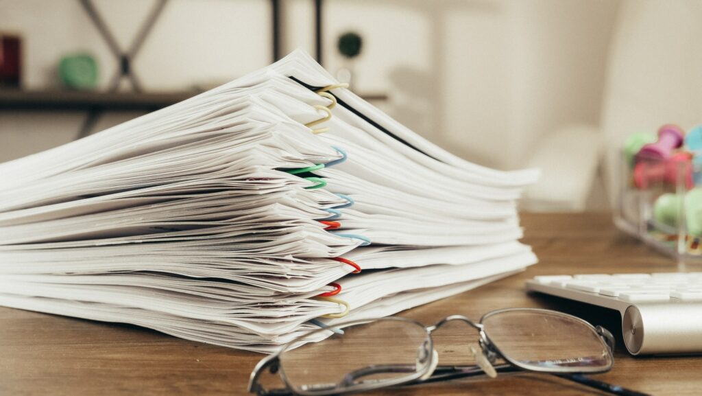 Paperwork on a desk near glasses